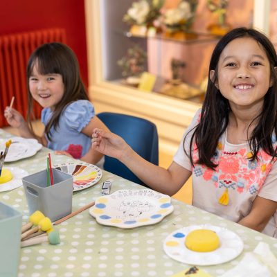 Image of 2 girls enjoying pottery painting fun